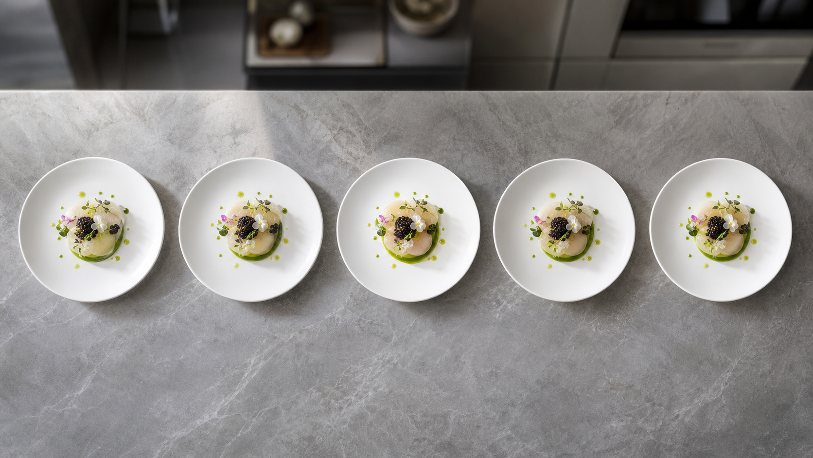 Five identical plates of a gourmet dish arranged in a row on a professional kitchen counter for comparison.