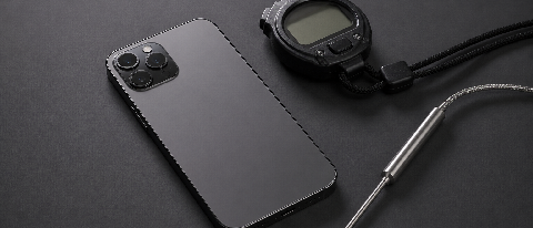 A minimalist editorial setup of a smartphone with professional testing tools.