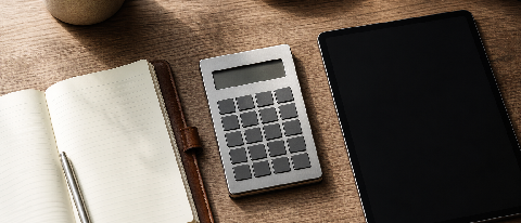 A minimalist desk setup showing a calculator next to a sleek notebook, symbolizing financial assessment and practical application.