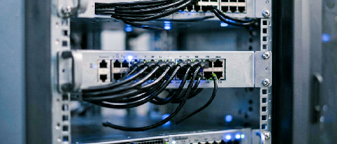 A sleek, modern server rack with organized cabling and subtle blue LED indicators, representing robust backend infrastructure and distributed systems.