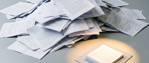 Editorial cover image: a vast scattered pile of rejected resumes dwarfing a tiny shortlisted stack on a minimalist desk, symbolizing brutal AI internship screen