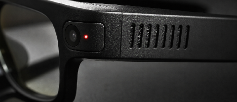 Close-up of smart glasses temple with heat dissipation vents and a red LED camera indicator