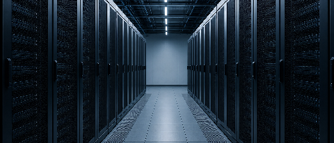 Empty server racks in a dimly lit data center representing idle computing power