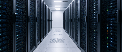 A high-angle editorial shot of a modern, clean data center aisle with server racks, emphasizing order and efficiency without visible text.