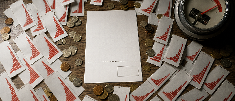 An overhead view of a desk cluttered with multiple printed billing statements showing exponential cost increases, surrounded by scattered coins and a single, di