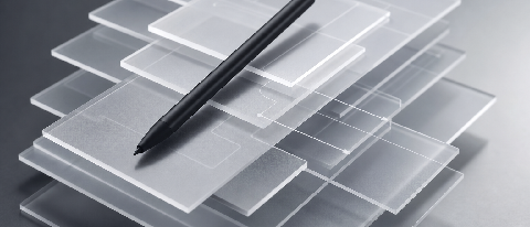 A conceptual editorial image showing a hand holding a stylus over a glowing digital blueprint, representing human creative control over AI-generated structures.