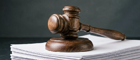 A gavel resting on a stack of legal documents with a subtle digital glitch effect