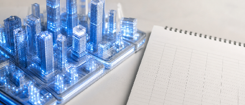 A glowing city model beside an empty ledger.