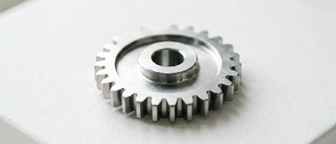 A minimalist editorial still life showing a small, precise mechanical component on a clean workbench, symbolizing the 'Flash' version and careful initial testin