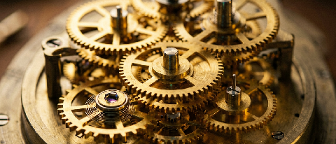 A complex mechanical clockwork mechanism with golden gears, illuminated by warm dramatic lighting, symbolizing slow, expensive precision.