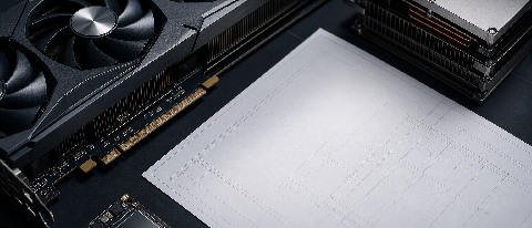 A professional editorial shot of high-end GPU components and a blank blueprint on a dark technical surface.