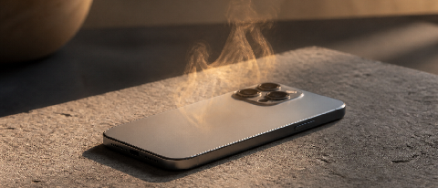 A smartphone resting on a surface with subtle heat haze distortion, symbolizing thermal limits.