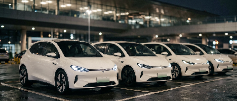 Autonomous robotaxis waiting in line at an airport terminal at night