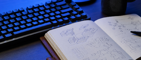 A sleek, modern workspace featuring a minimalist mechanical keyboard and a notebook with technical diagrams, bathed in cool blue light representing stability an
