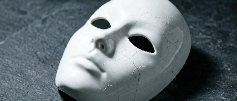 A pristine white ceramic mask resting on a dark surface with subtle, almost invisible cracks, symbolizing hidden flaws in seemingly perfect digital content.