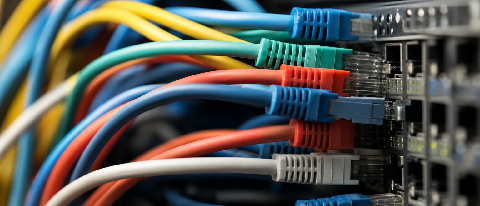 A detailed view of complex server cabling and data infrastructure representing backend integration challenges