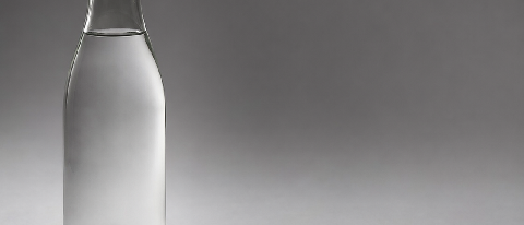 A beverage bottle on a studio surface with a shadow pointing in the wrong direction, with a gap where the shadow disappears.