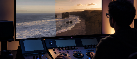 A monitor in a dark editing suite displaying color artifacts from AI footage.