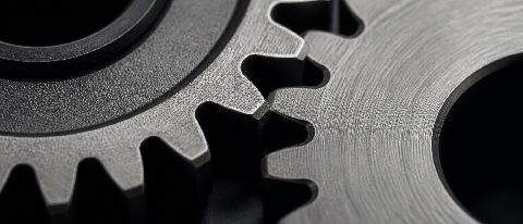 Macro photography of a precision mechanical gear assembly with a blurred background, symbolizing optimized system performance.
