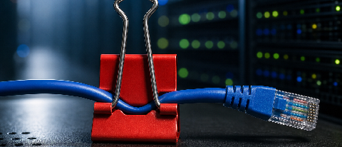 A network cable clamped by a red binder clip, representing a communication choke point in an AI cluster.