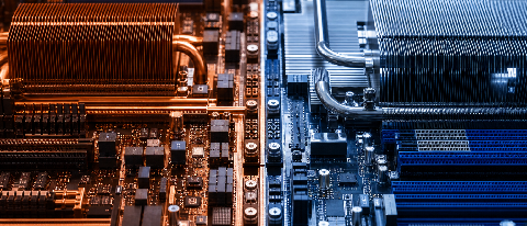 A close-up editorial shot of a complex circuit board with distinct red and blue pathways, symbolizing the transition between two different computing architectur
