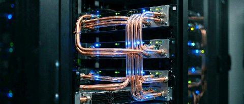 A modern data center server rack with liquid cooling pipes and blue ambient lighting