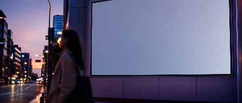 A cinematic street scene with a large blank LED screen in the background