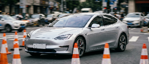 A sleek electric vehicle navigating a complex intersection with construction barriers and blurred motion, emphasizing smooth, intuitive driving paths.