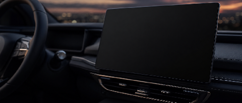 A blurred, out-of-focus view of a modern car dashboard with empty space where a screen or map should be, symbolizing missing information.