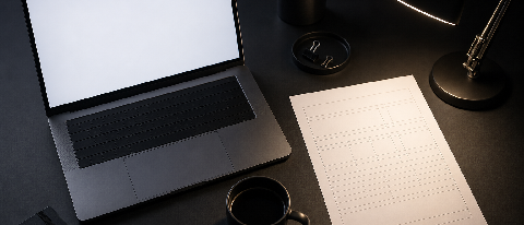 A glowing digital dashboard with financial columns shown as blank placeholders on a dark desk